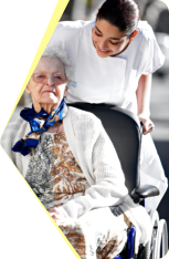 elderly in a wheelchair with her caregiver
